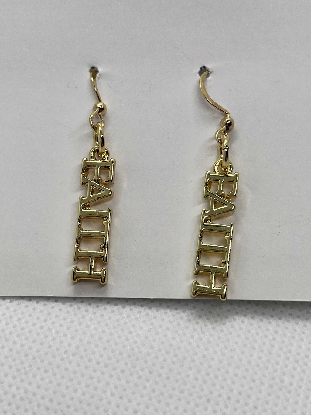 14K gold faith dangle earrings with FAITH block lettering and curved hooks