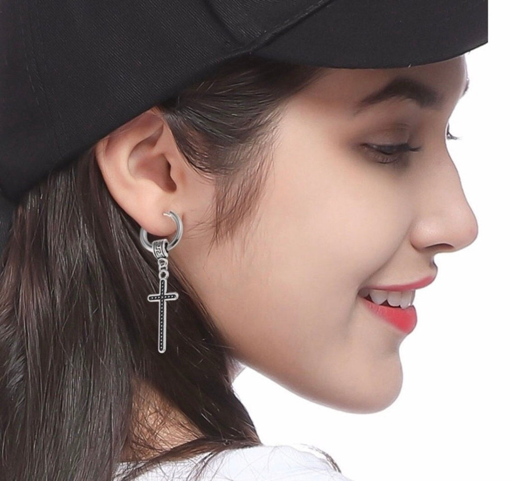 Silver-tone hoop cross earrings with Celtic knot detail, profile closeup