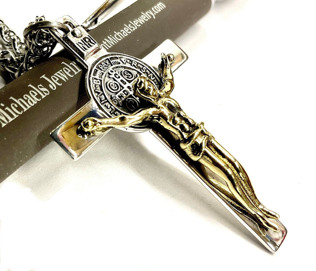 Metal crucifix pendant with detailed Jesus figure and saint Benedict medallion