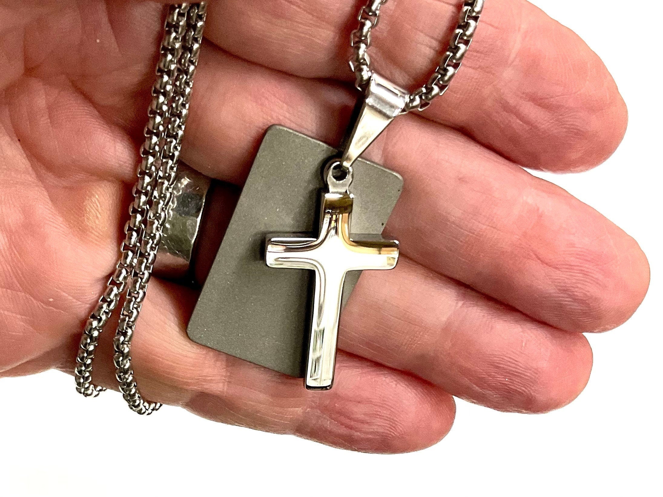 Silver cross dog tag necklace pendant close-up with chain