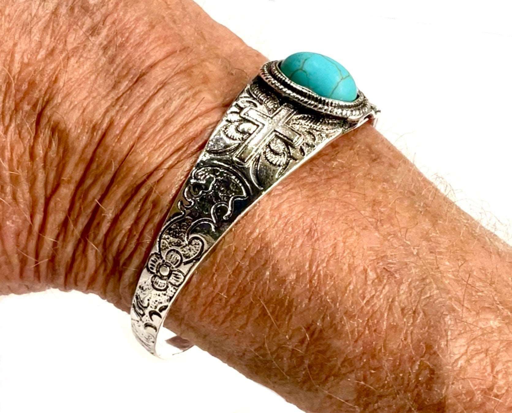 Silver-tone bangle cuff bracelet with turquoise oval stone and engraved cross pattern