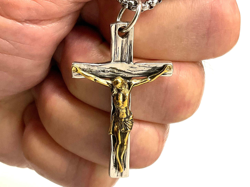 Crucifix cross pendant with gold-toned figure on a silver bail and chain