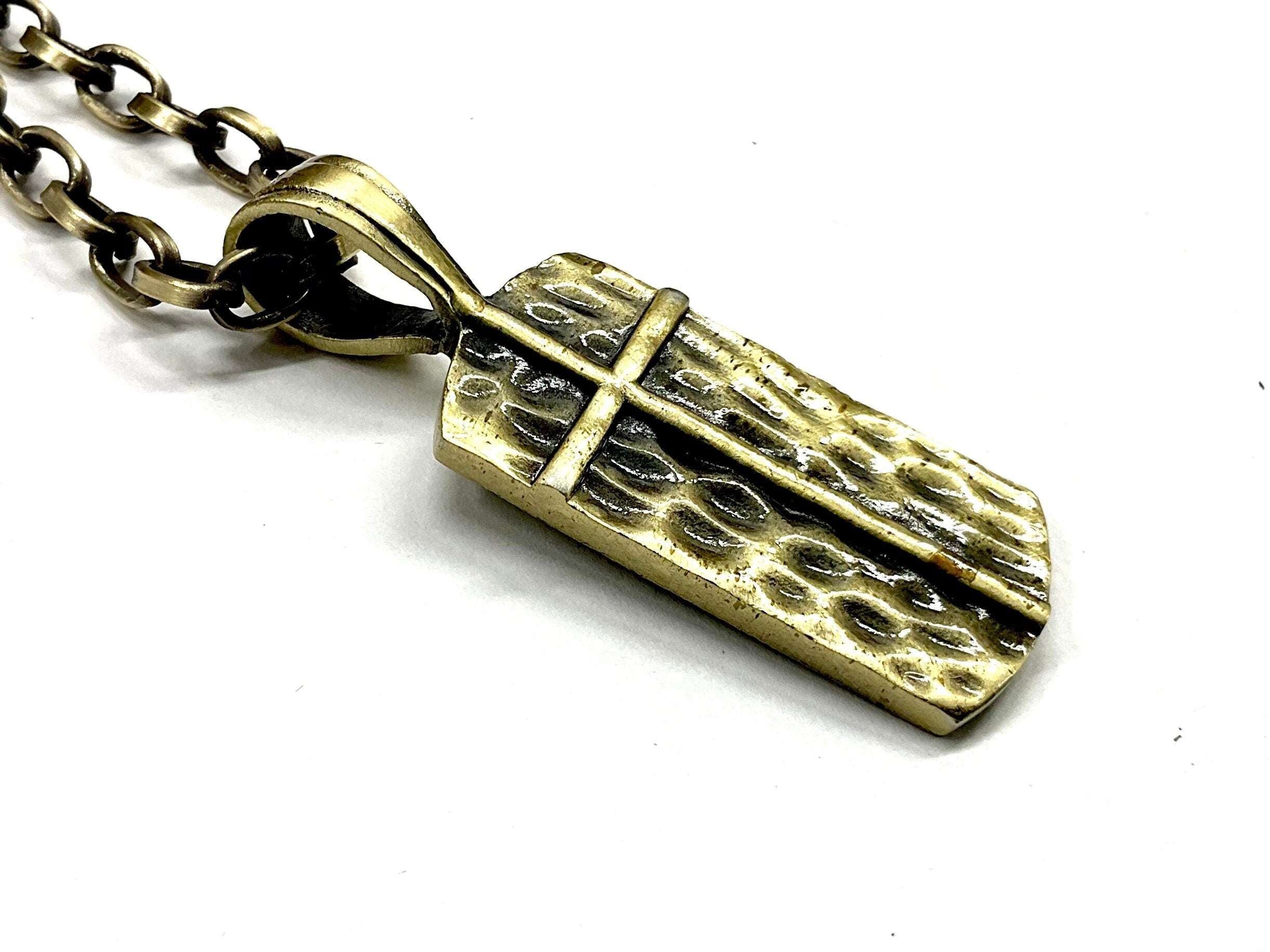 Bronze dog tag pendant with chain, close-up of crucifix and cross detail