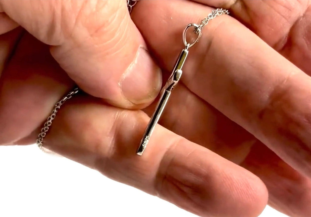 Sterling silver cross pendant necklace clasp detail held in fingers