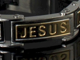Silver link bracelet close-up with engraved JESUS letters in gold panels