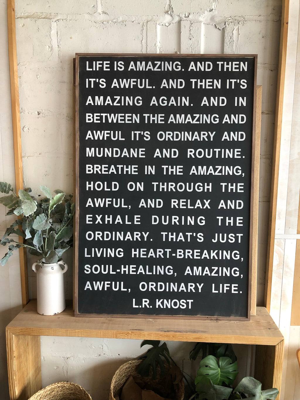 Wood-framed chalkboard wall sign with quote text and L.R. Knost beneath