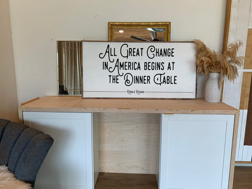 Rectangular wood wall sign with quote: “All Great Change in America Begins…”