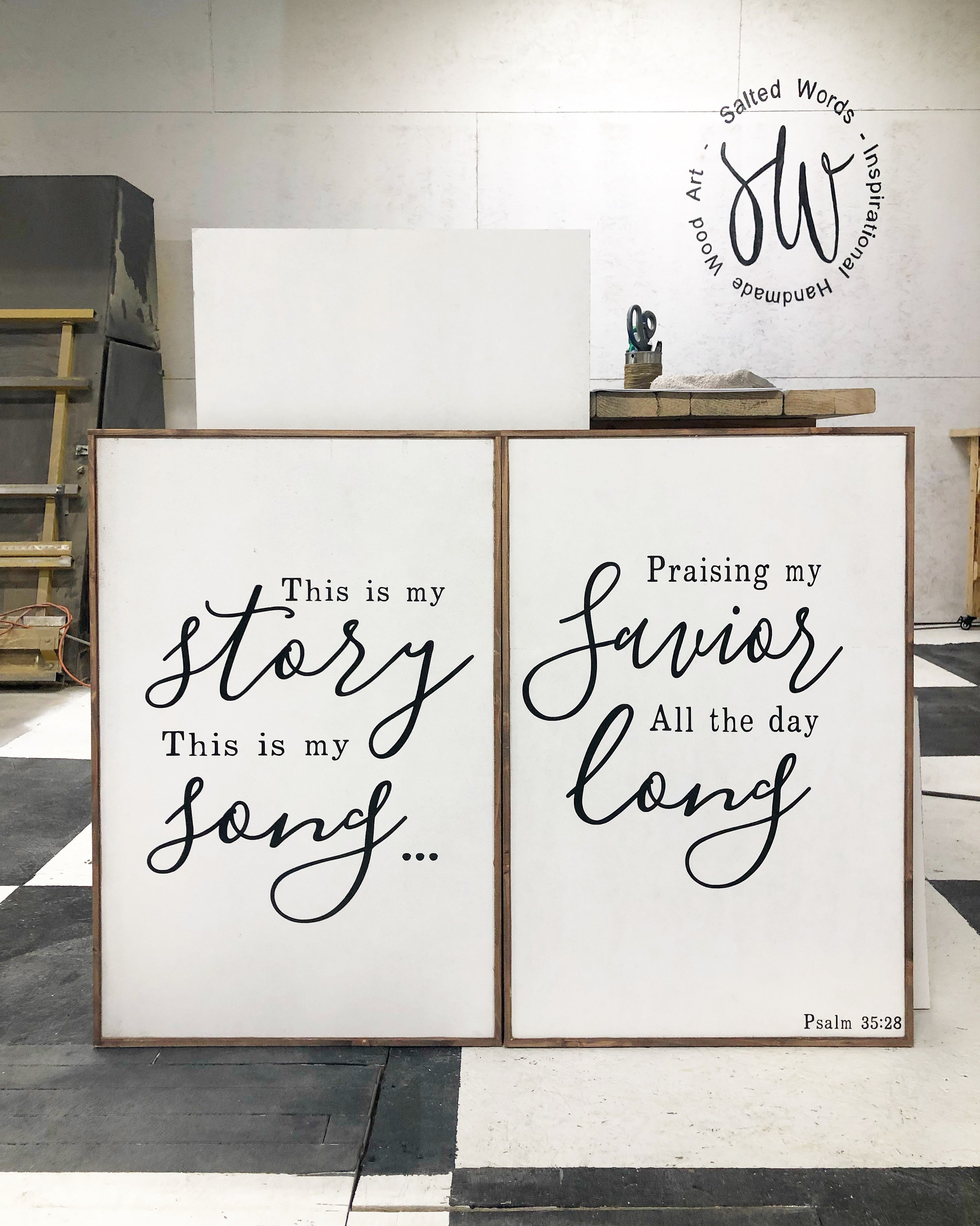 Framed wall art set of 2 with black script text: story/song and favor/long