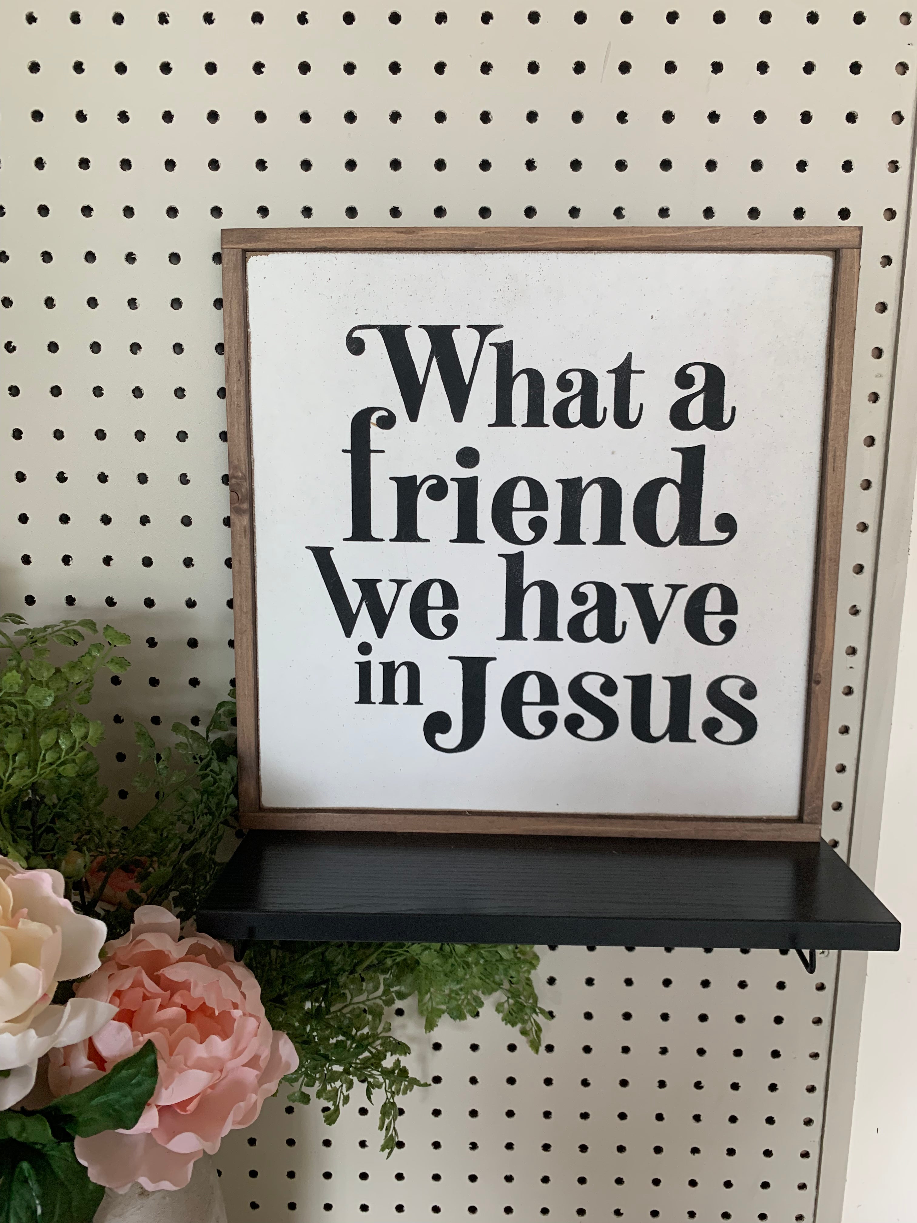Framed Christian wall sign with text “What a friend, we have in Jesus”.