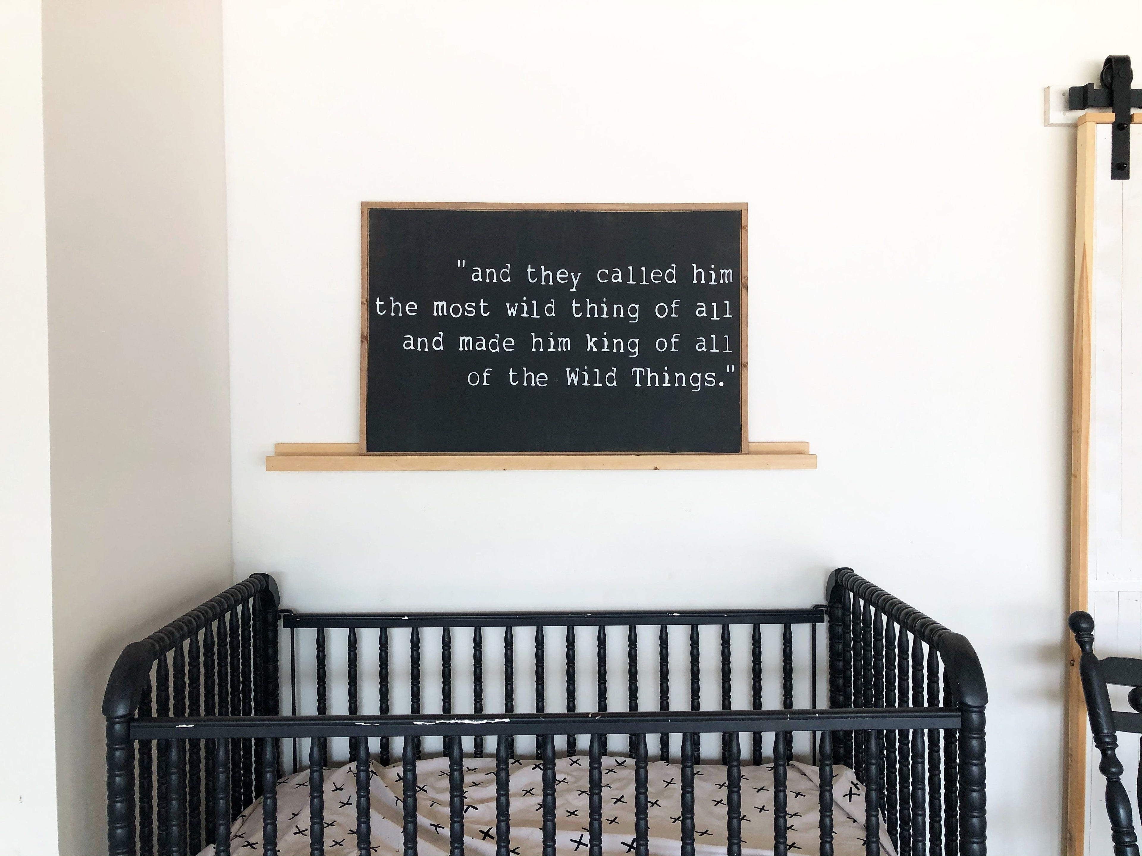 Wood-framed chalkboard wall hanging with quote text, dark center, light border.