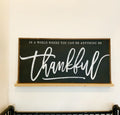 Framed farmhouse wall decor with black chalkboard and white script 'thankful'