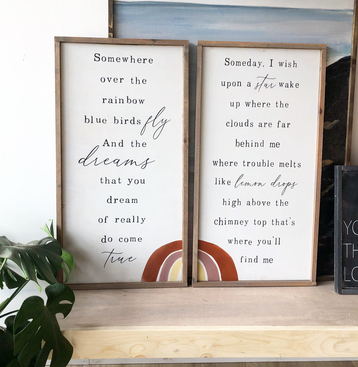 Pair of framed wall signs with printed poem text and rainbow arches