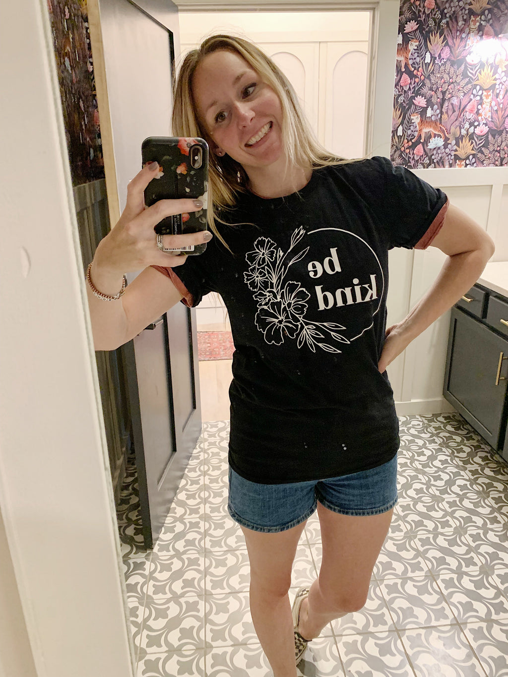 Black floral graphic T-shirt with 'be kind' front print