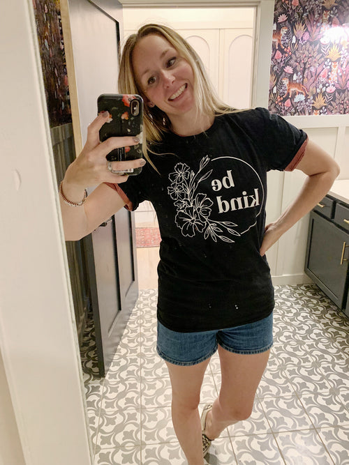 Black floral graphic T-shirt with 'be kind' front print