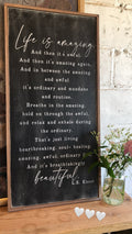 Framed wood interior sign with black background, white script quote and heart icons