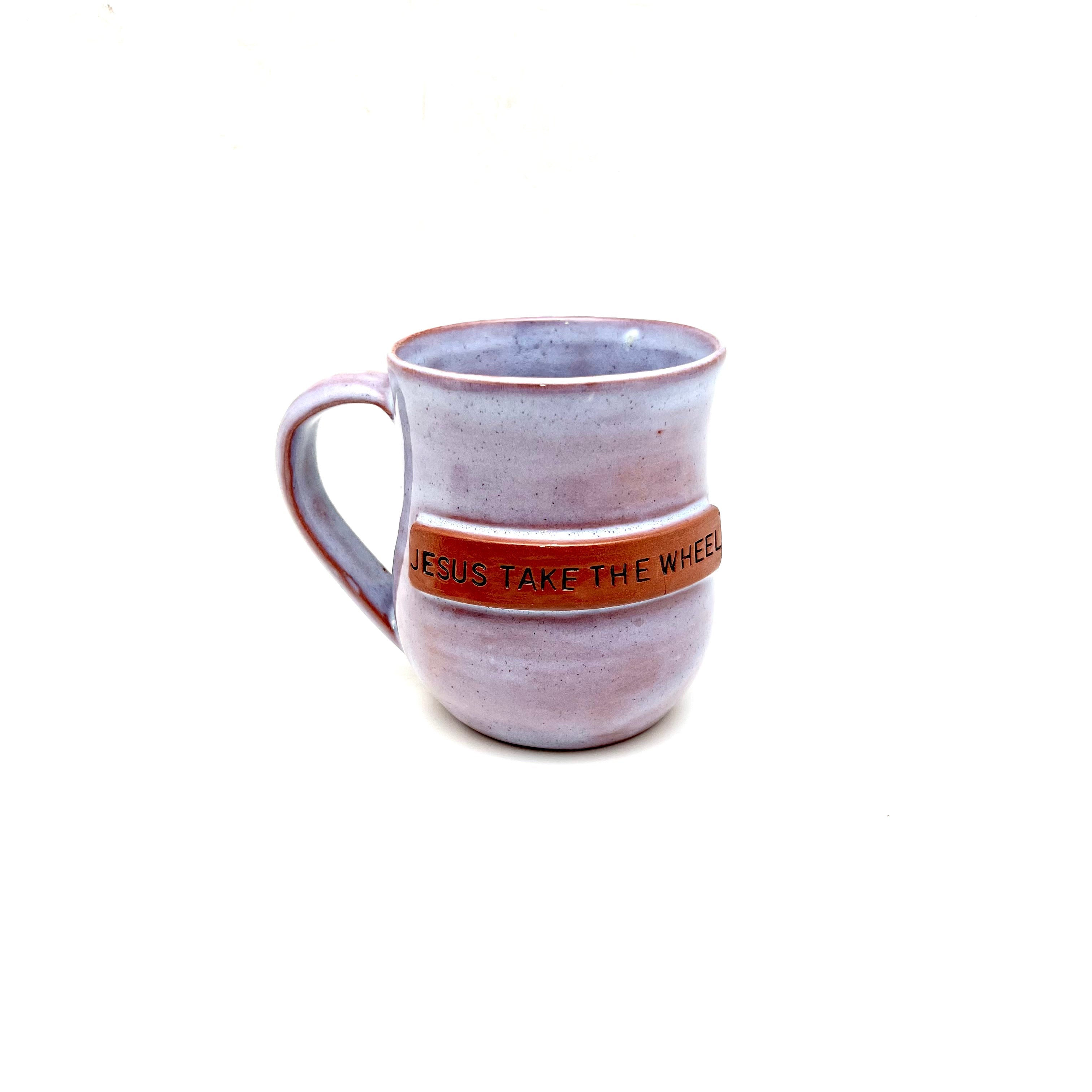 Ceramic mug with handle, purple glaze, text 'JESUS TAKE THE WHEEL' around center