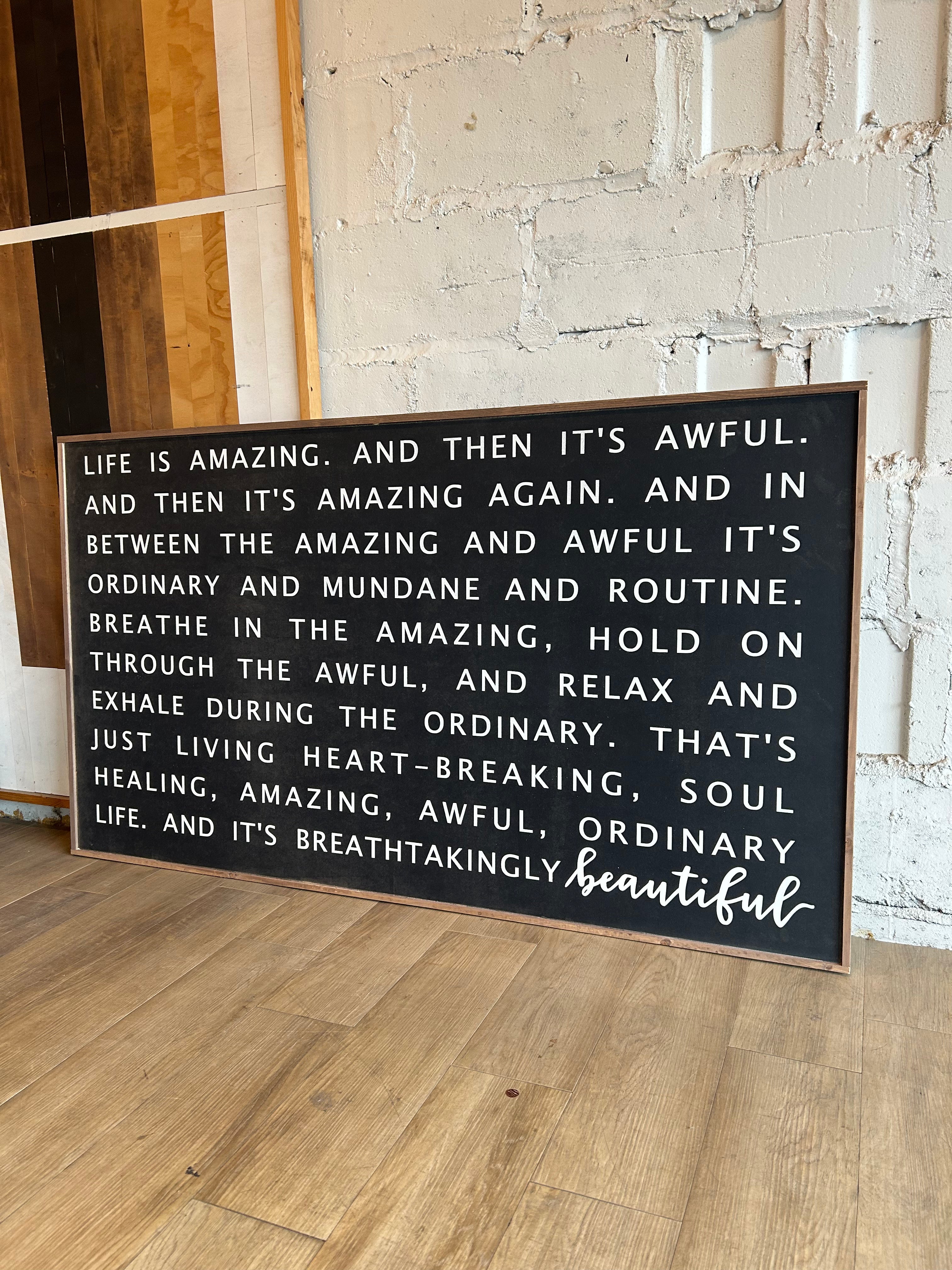 Wood interior decoration sign with inspirational quote text, dark lettering on light background