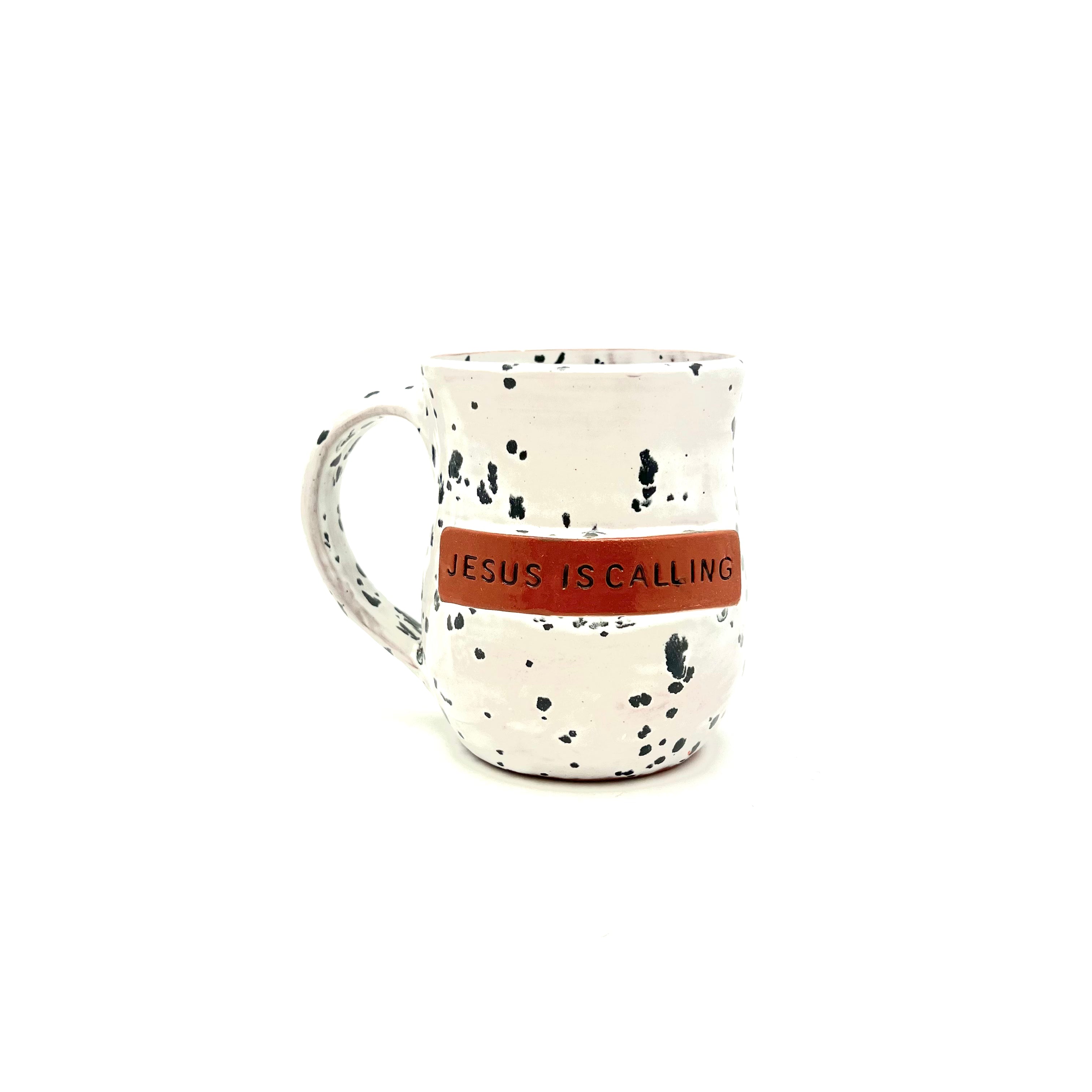 Speckled ceramic mug with handle, reads “JESUS IS CALLING”
