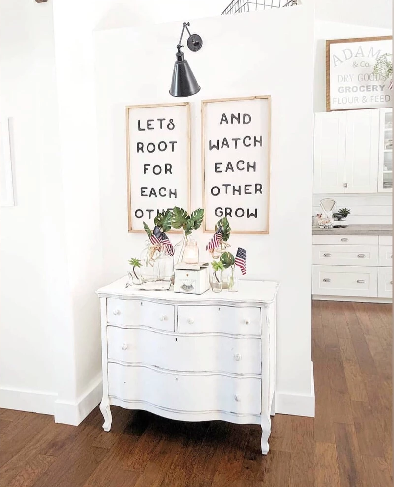 Framed wood wall signs with black text: LET’S ROOT FOR EACH OTHER, AND WATCH