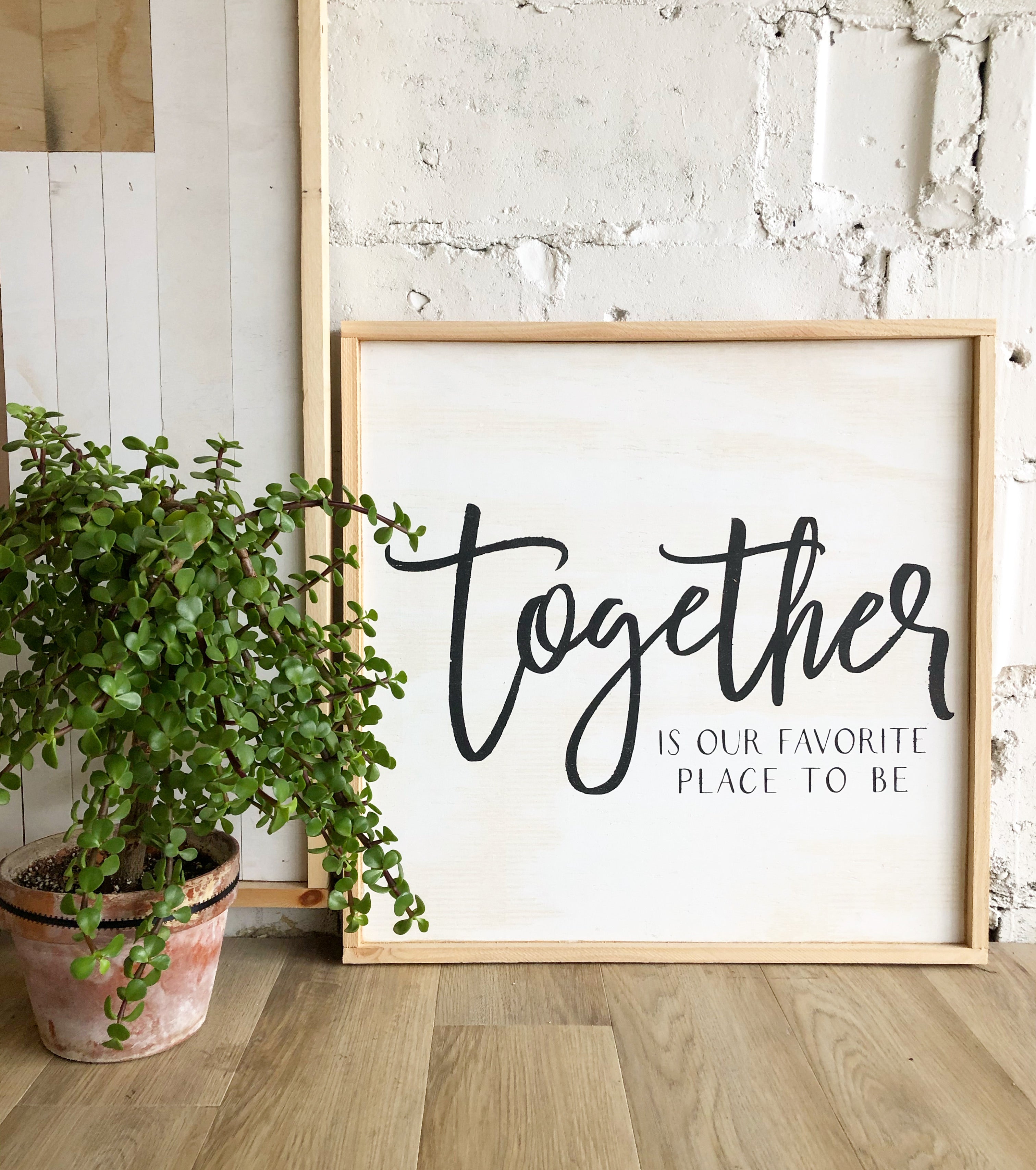 Framed wood wall art with black script 'Together' on white background