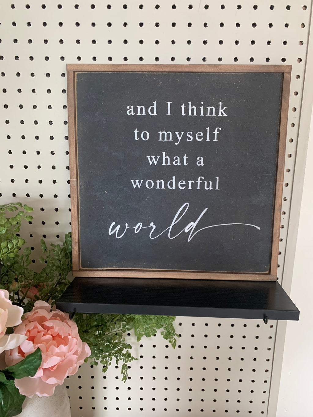 Framed wood quote sign with chalkboard insert and cursive message, 'world'