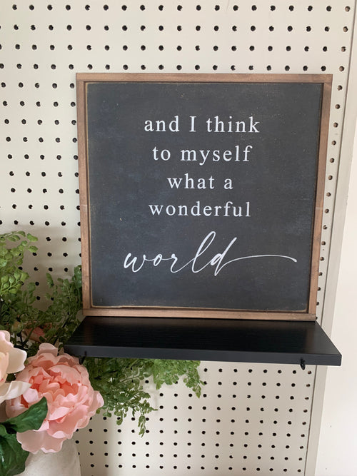 Framed wood quote sign with chalkboard insert and cursive message, 'world'