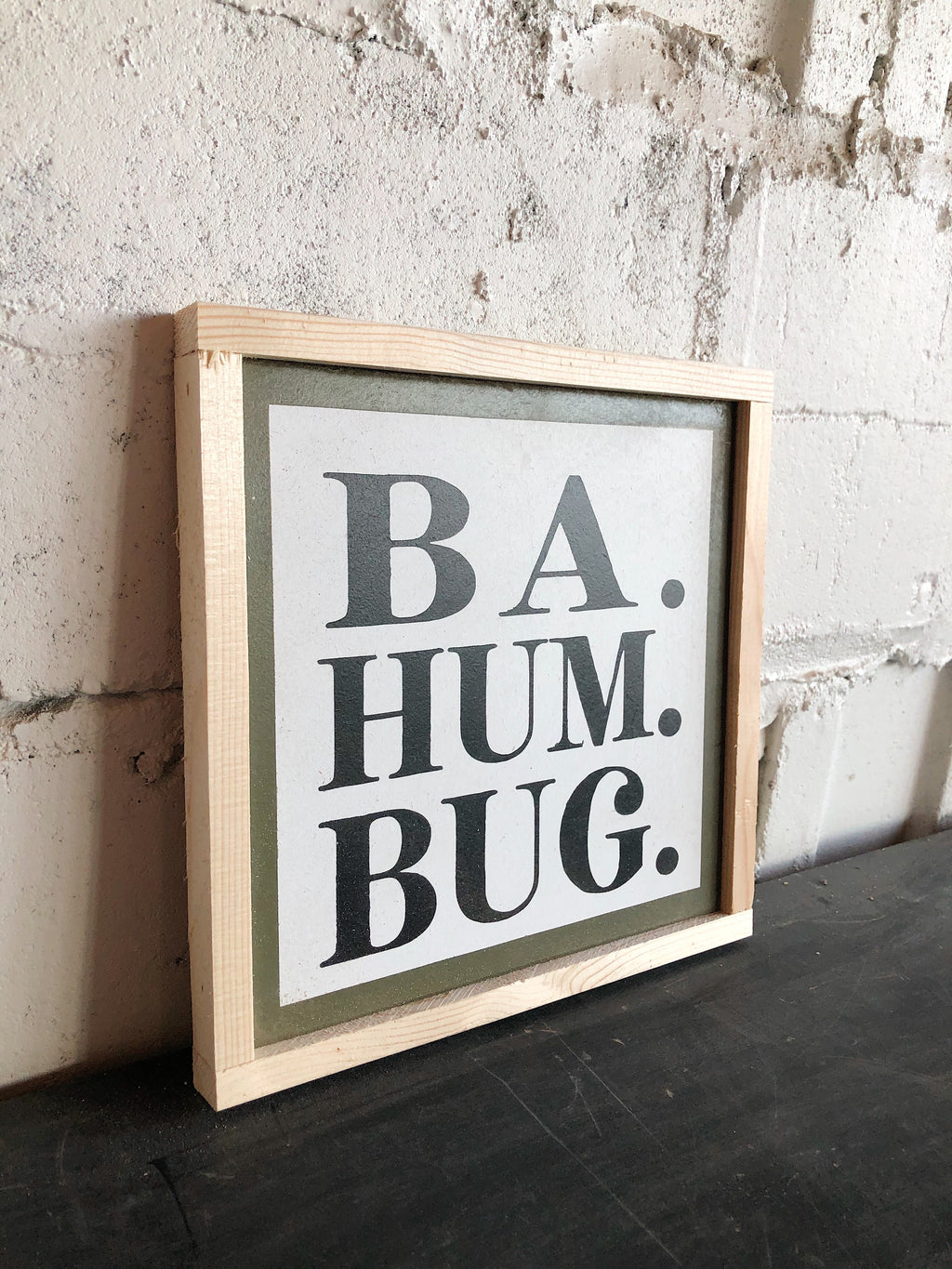 Framed wall art sign: 'BA. HUM. BUG.' black text on light background