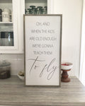 Framed wall quote sign with handwritten-style quote and 'to fly' script