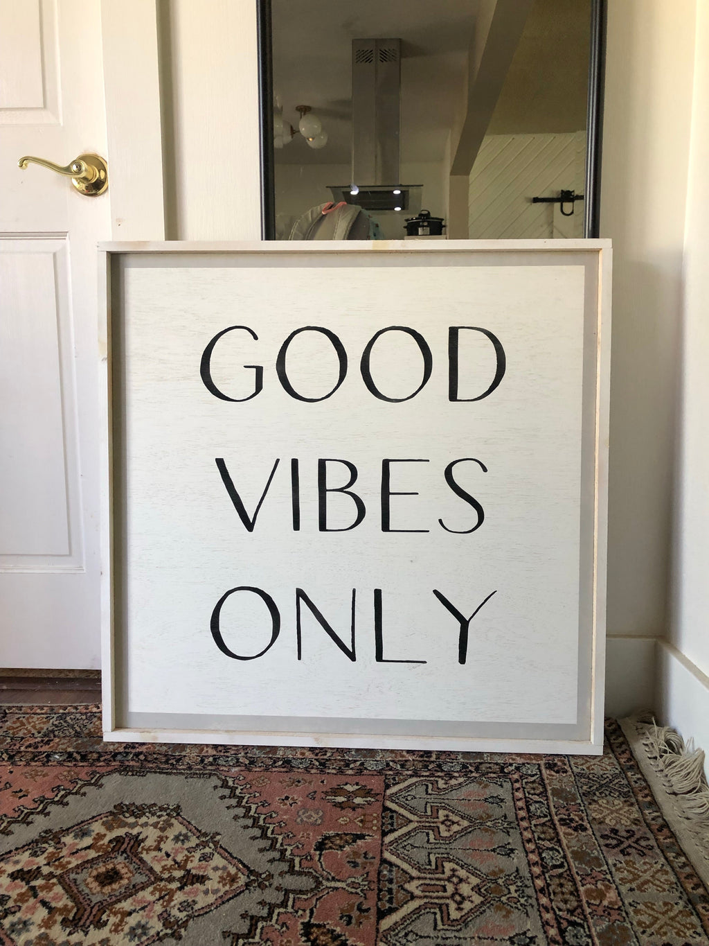 Framed wood wall sign reading “GOOD VIBES ONLY” in black lettering