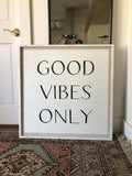 Framed wood wall sign reading “GOOD VIBES ONLY” in black lettering