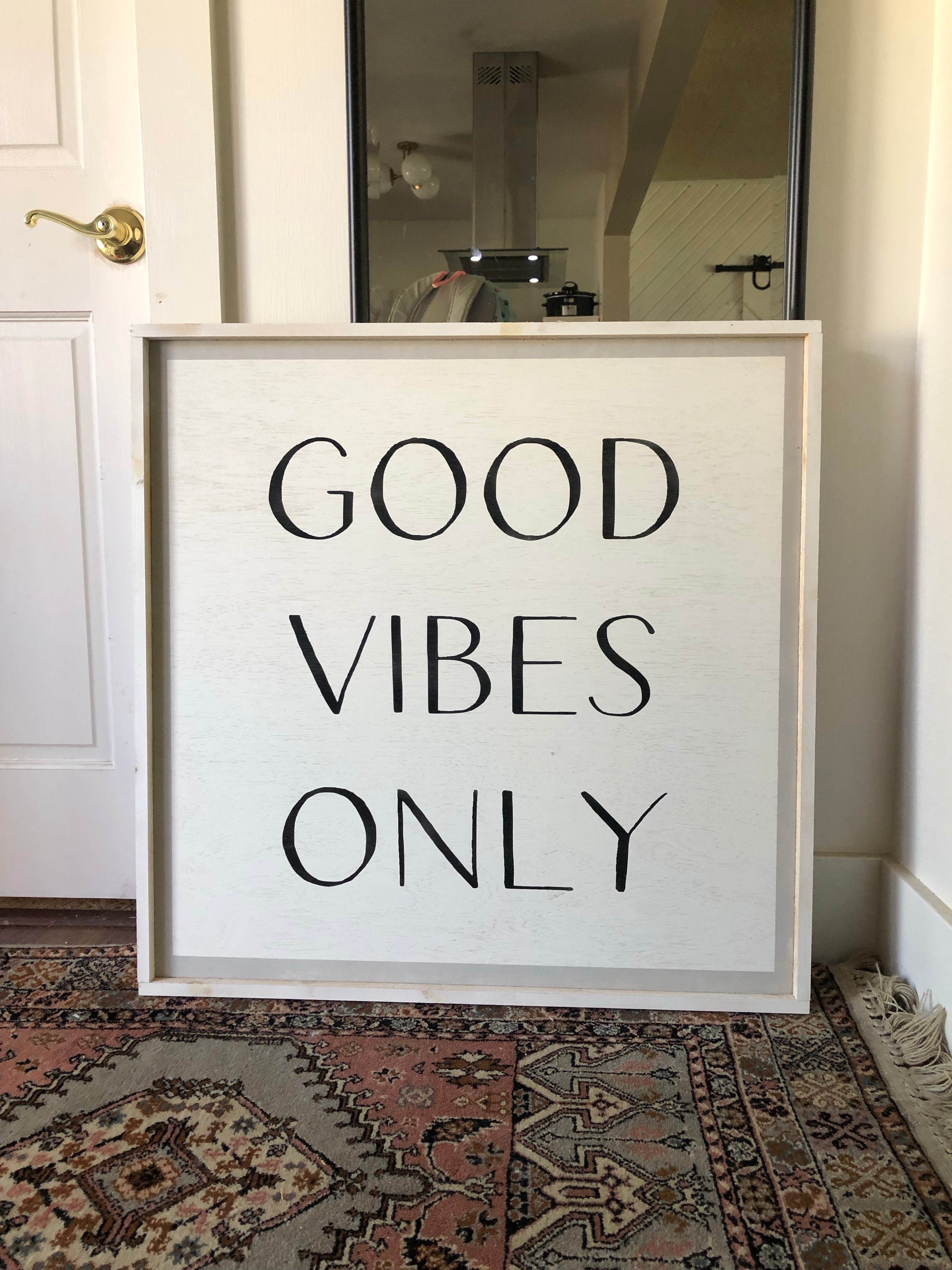 Framed wood wall sign reading “GOOD VIBES ONLY” in black lettering