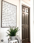 Framed quote sign with black text on white background and dark frame