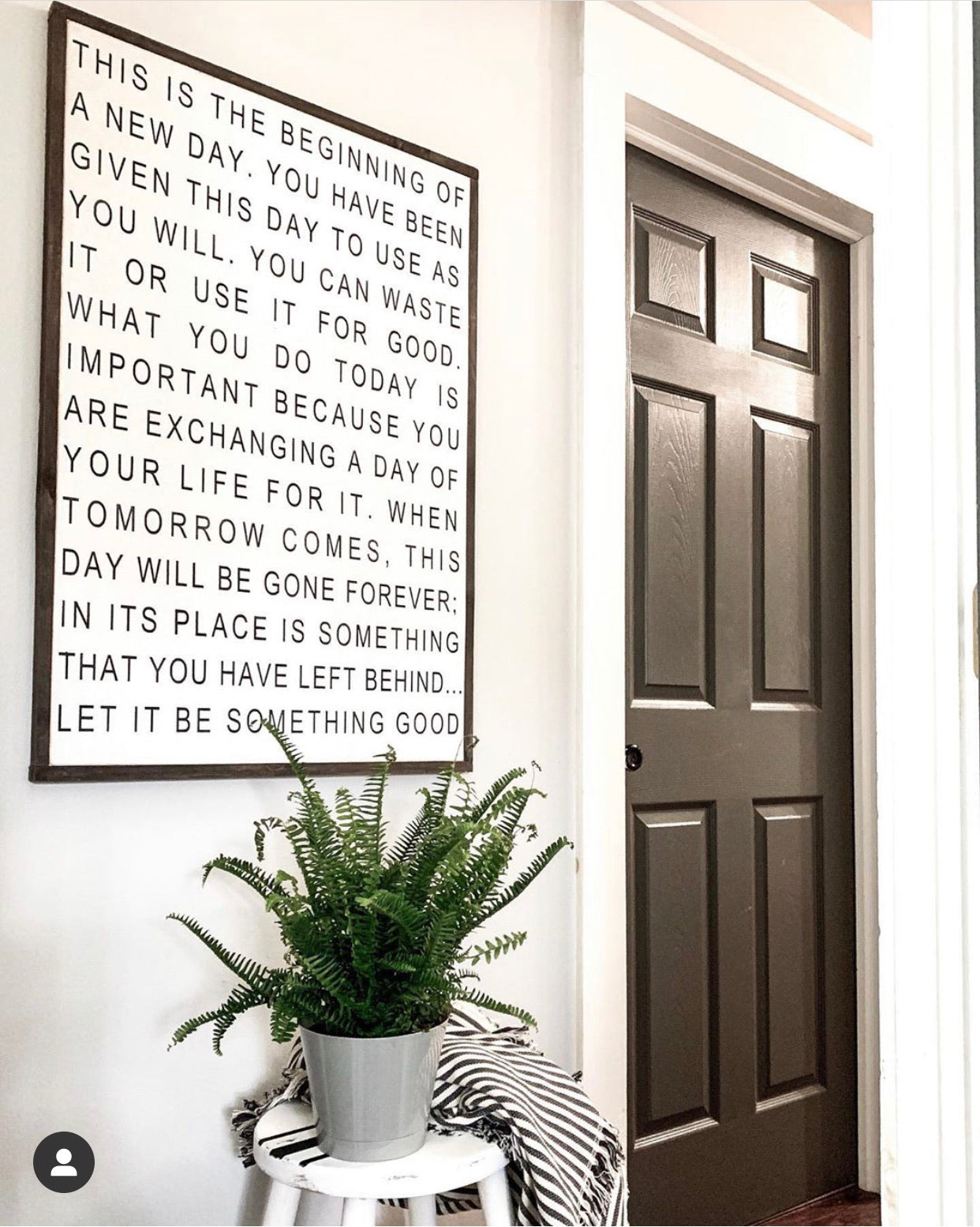 Framed quote sign with black text on white background and dark frame