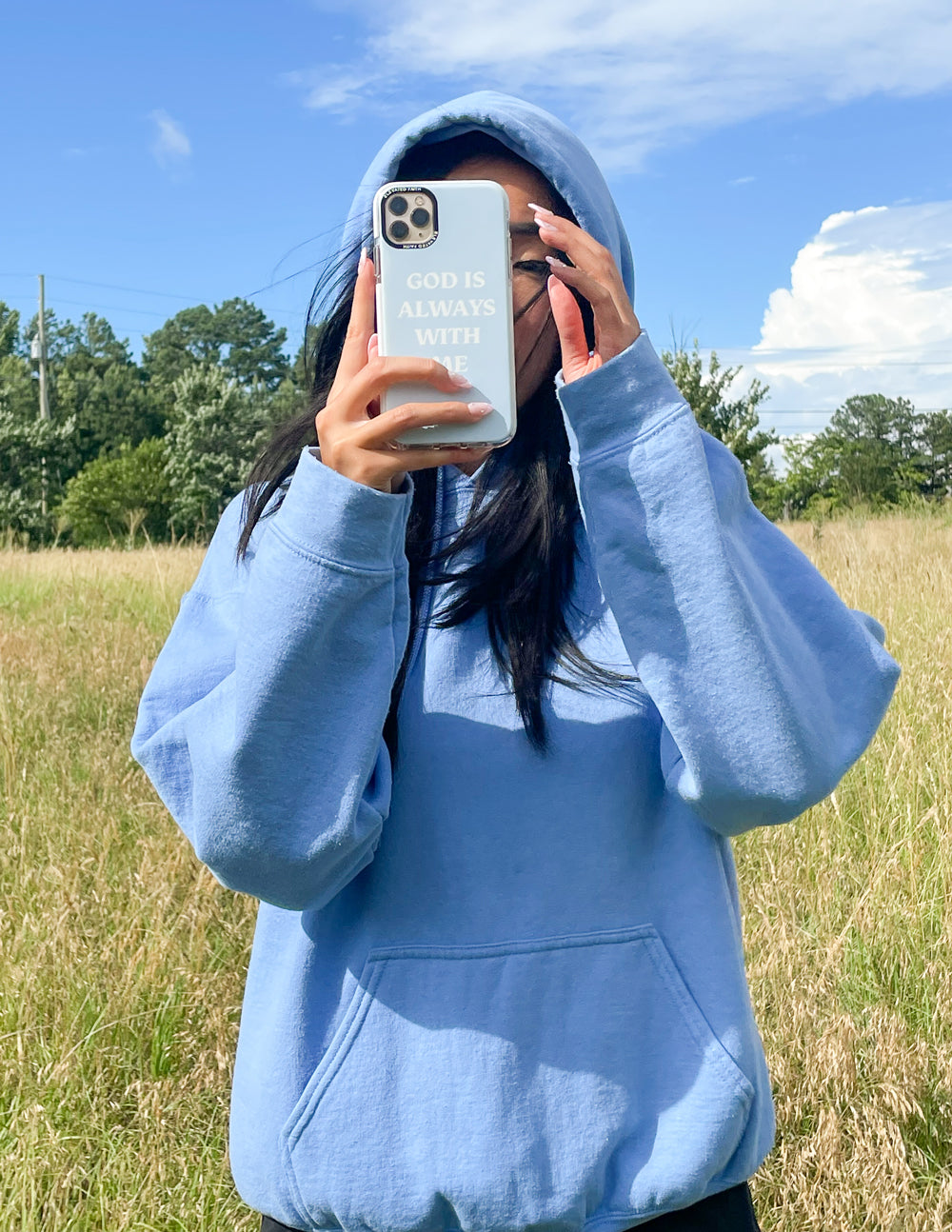 Light blue phone case: 'GOD IS ALWAYS WITH ME' with camera cutouts