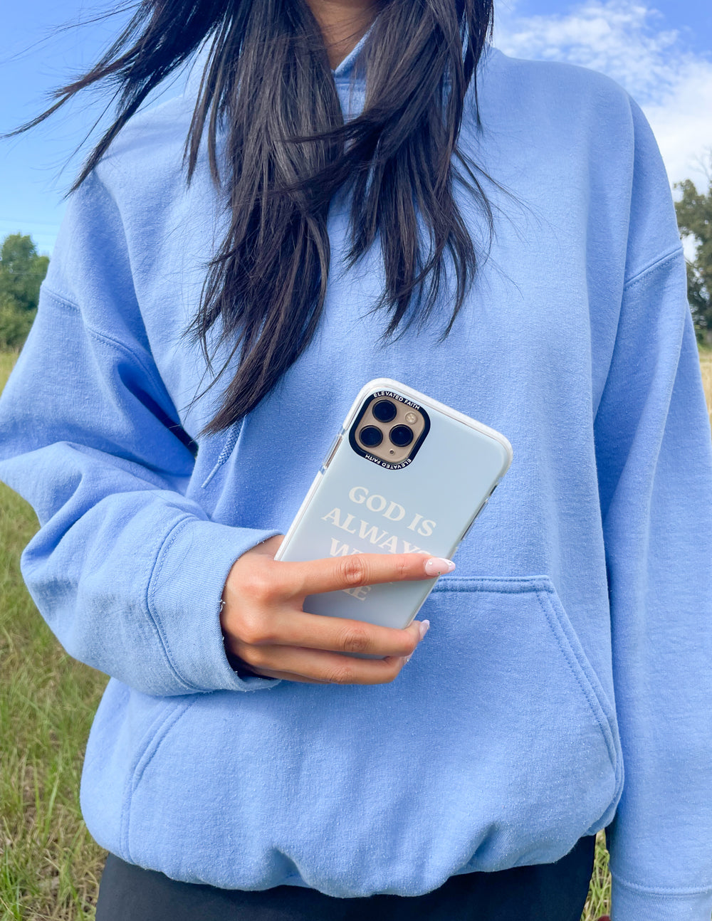 Light blue phone case with white 'GOD IS ALWAYS WITH ME' and camera cutouts