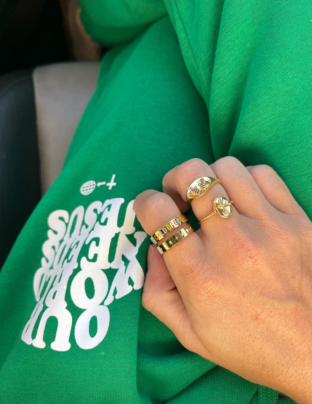 Gold butterfly signet ring on finger with engraved wing motif