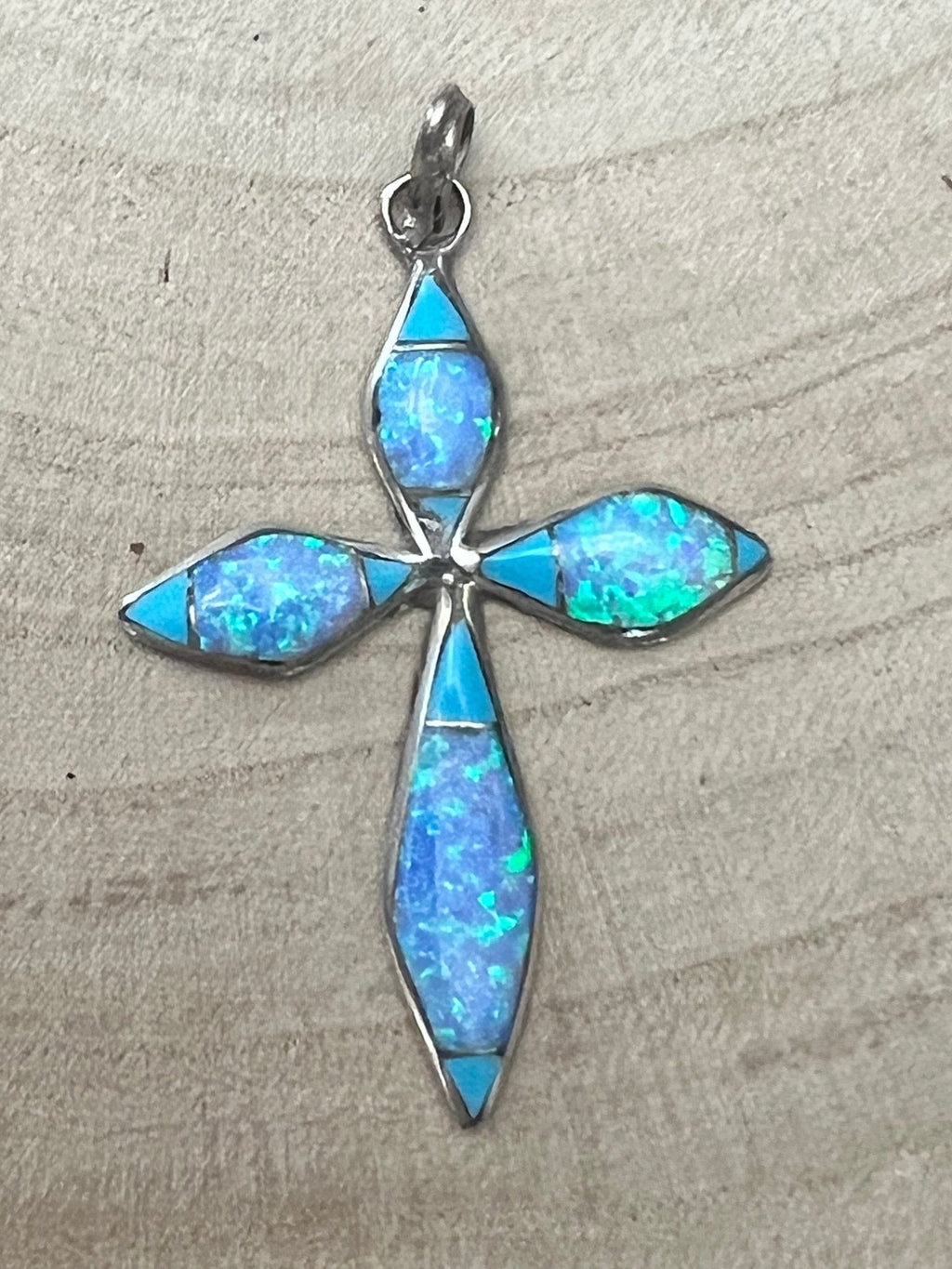 Turquoise opalite cross pendant with silver-tone inlay, teardrop shapes and loop bail