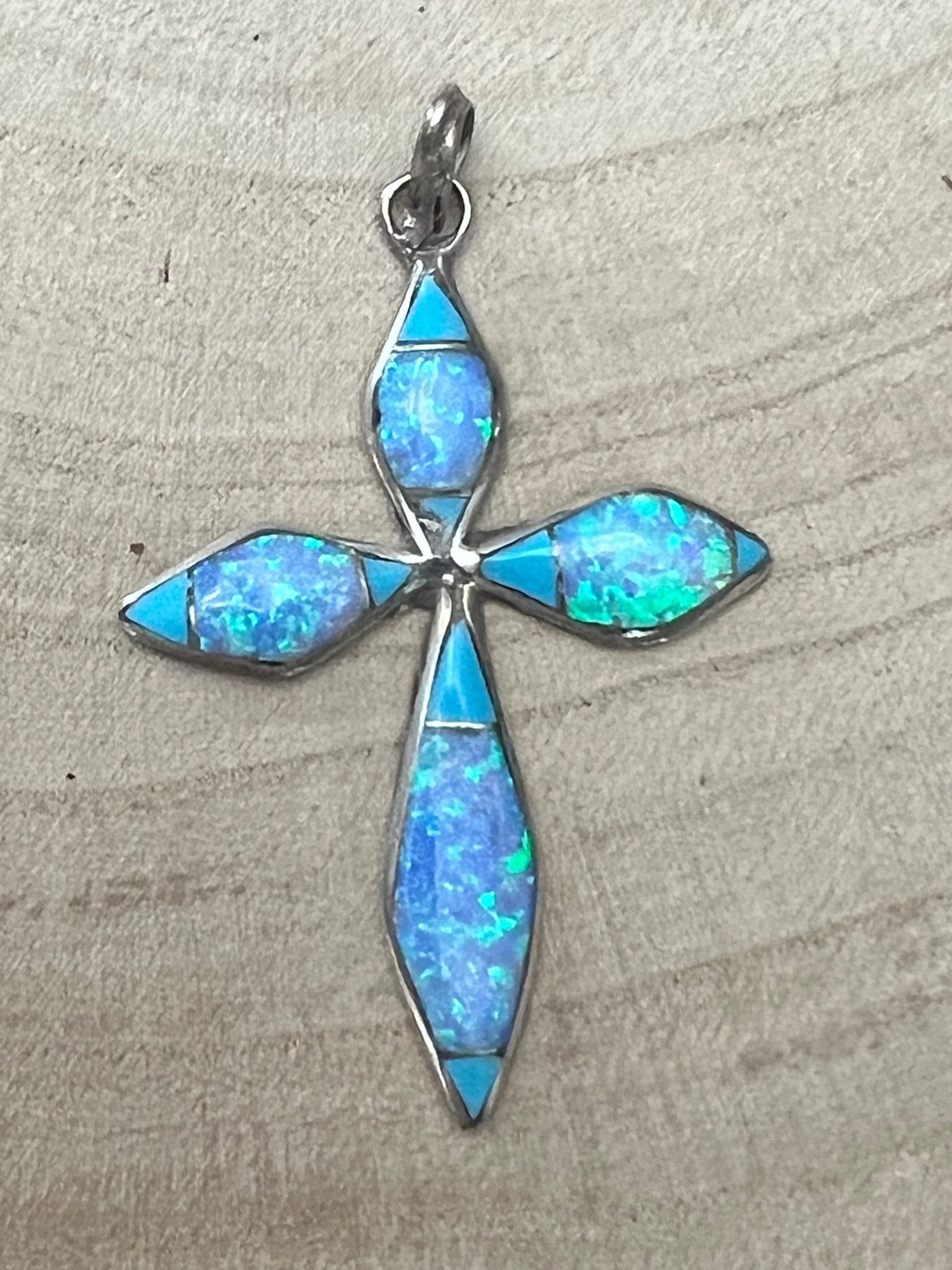 Turquoise opalite cross pendant with silver-tone inlay, teardrop shapes and loop bail