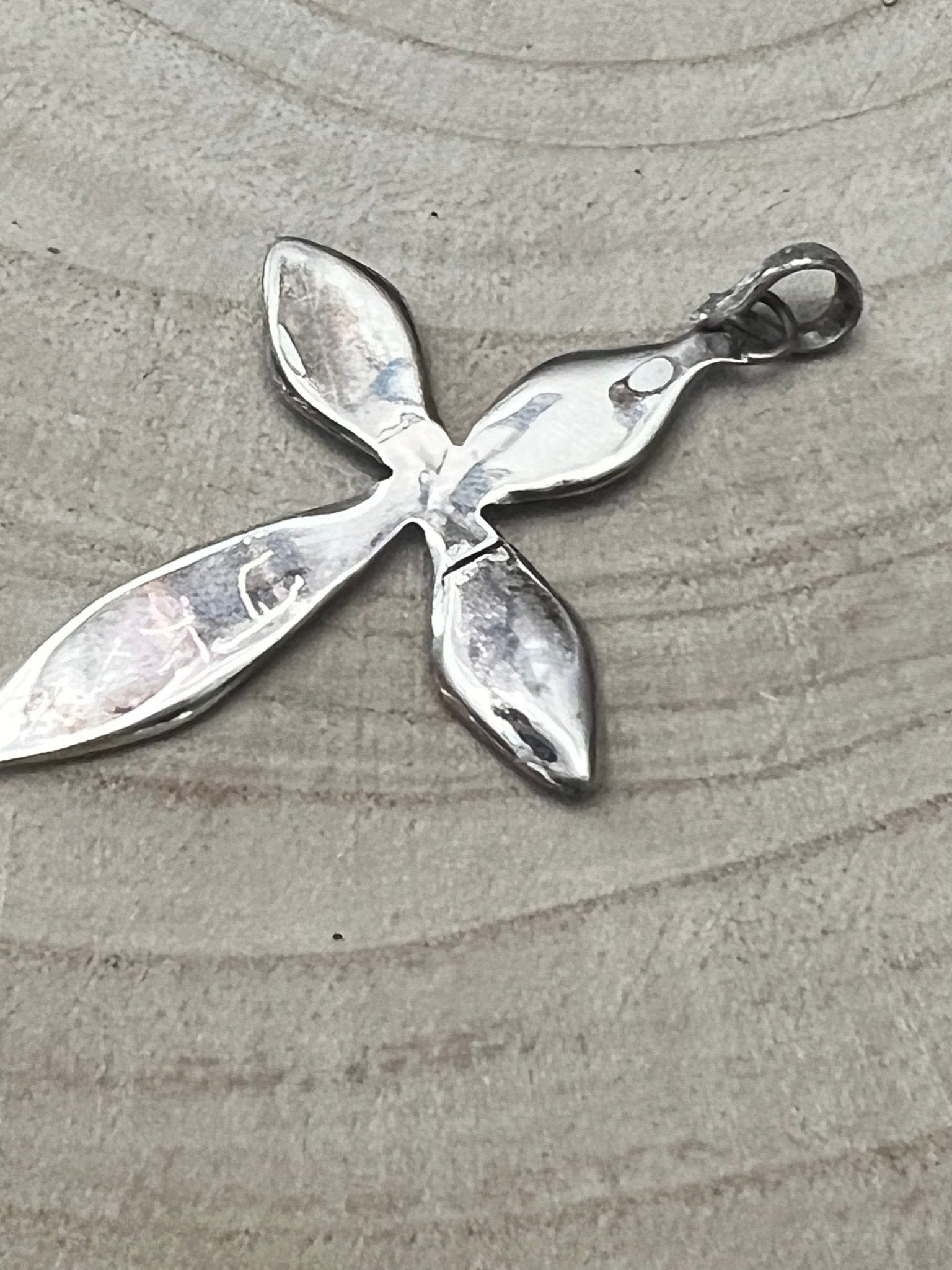 Silver-tone cross pendant with five petal shapes and loop bail