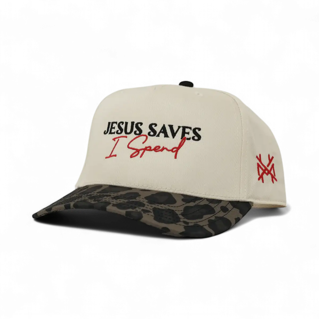 Cream baseball cap with 'JESUS SAVES' and 'I Spend', camo brim, side logo
