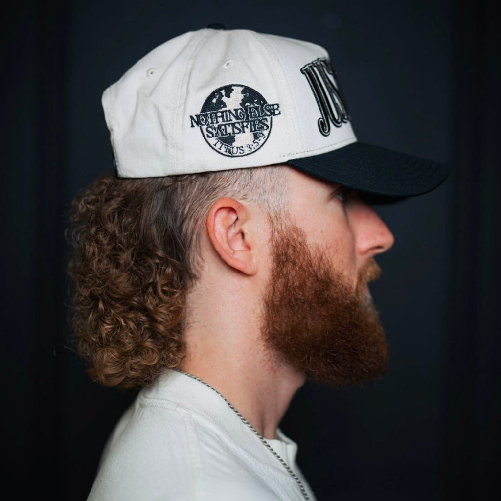 Cream snapback cap with black underbrim and circular "NOTHING ELSE" patch.