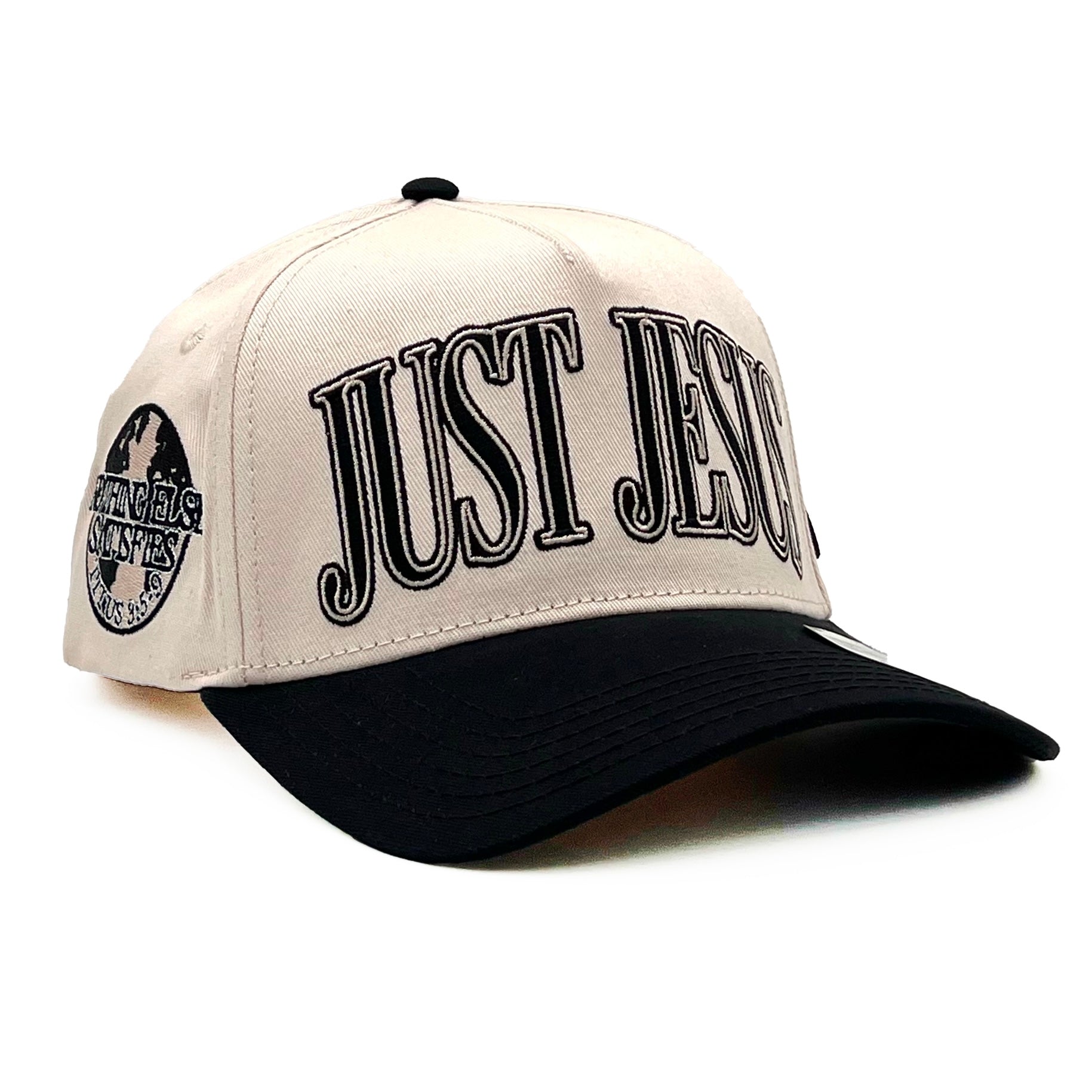 Cream and black snapback cap with embroidered "JUST JESUS" front; curved brim.