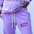 Neon violet sweat shorts with drawstring and 'Jesus' faith logo on leg