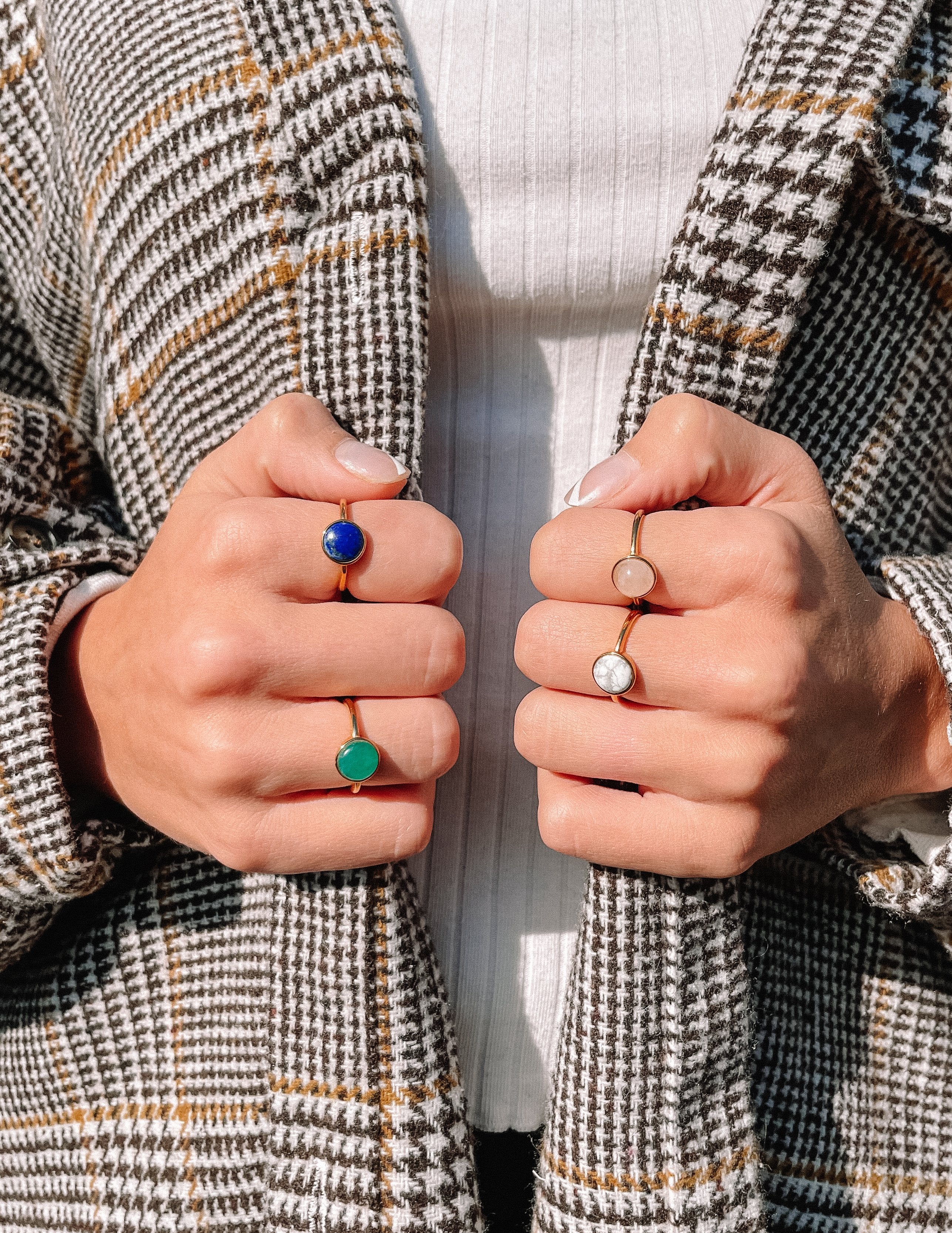 Lapis lazuli ring on left hand with blue round cabochon.