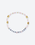 Beaded letter bracelet with pink beads, gold-tone charms, and spaced love text.