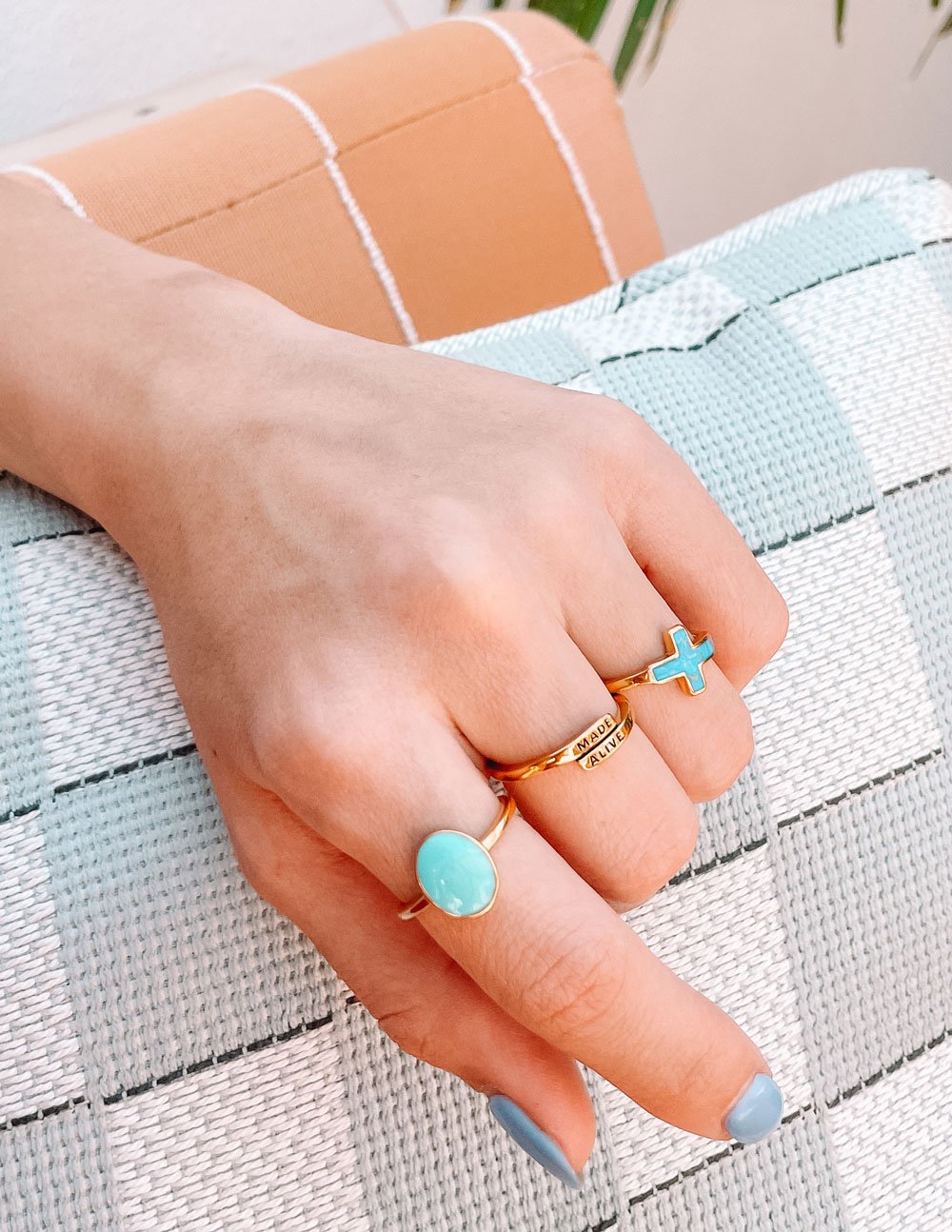 Gold ring with "MADE ALIVE" engraving on hand