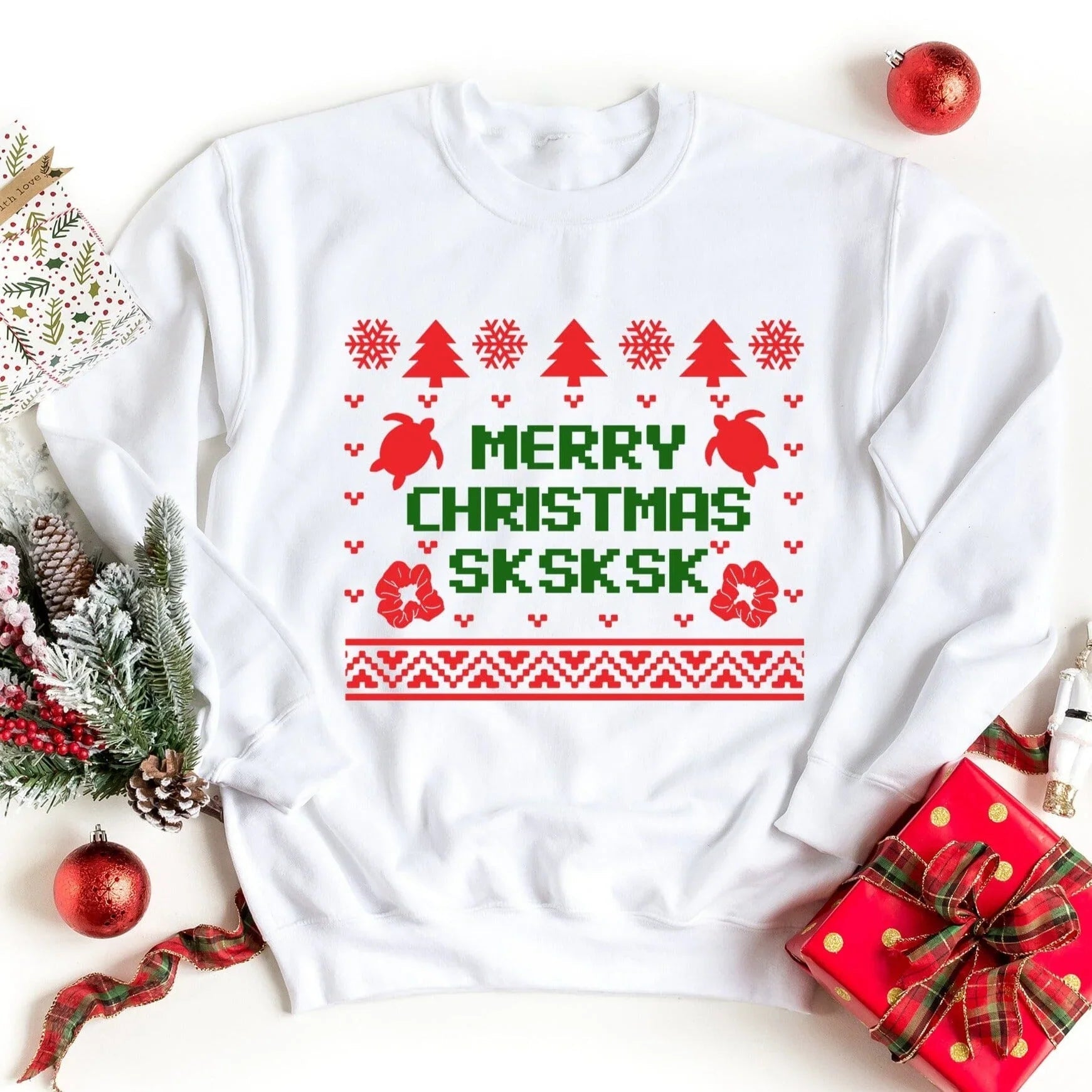 White crewneck sweatshirt with Christmas trees, reindeer, and red/green holiday graphic