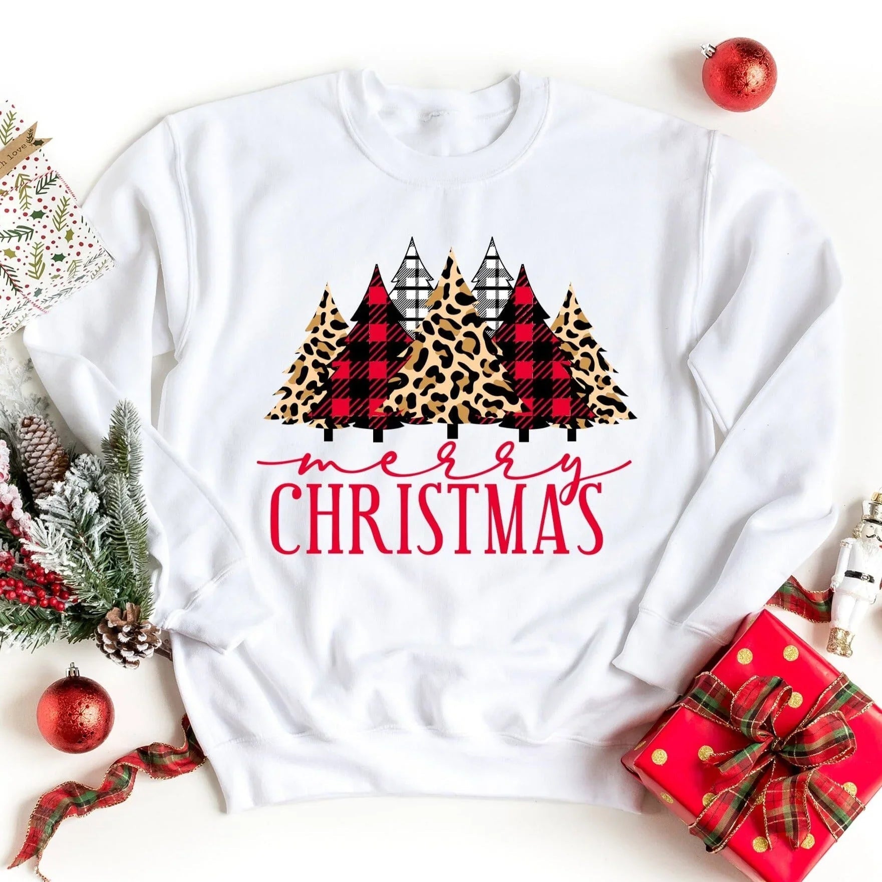 White crewneck sweatshirt with leopard plaid Christmas tree graphic and Merry Christmas text