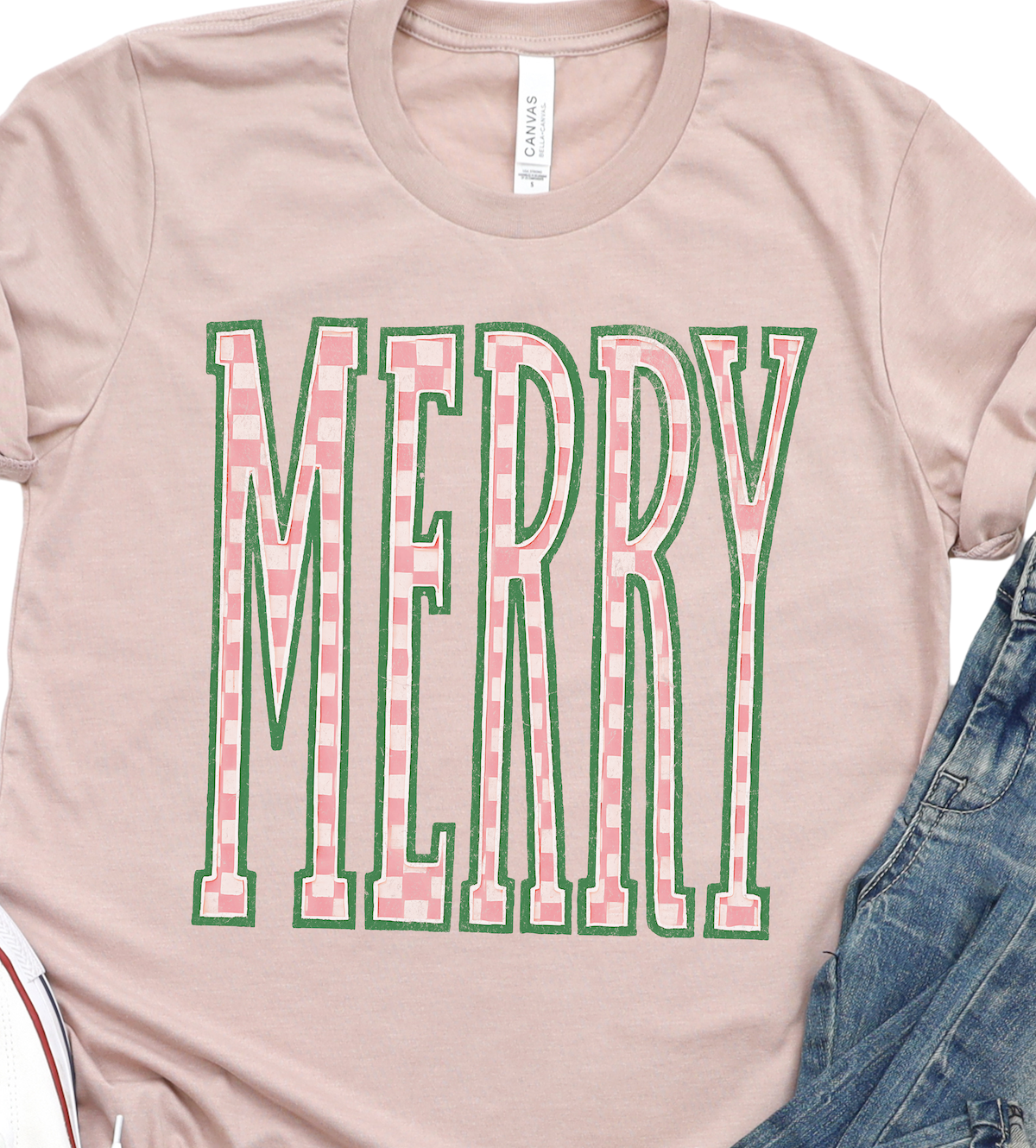 Pink T-shirt with large green plaid MERRY graphic on front