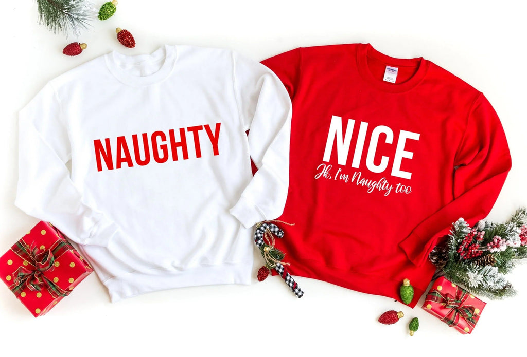 Two sweatshirts: white 'NAUGHTY' and red 'NICE' with small script